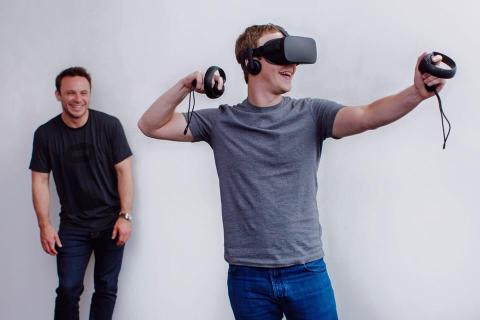 Zuckerberg (right) tests out Oculus' Rift headset and motion sensing Touch controllers.