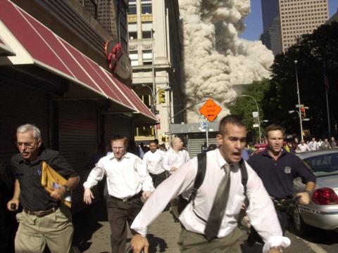People run from the collapse of World Trade Center Tower Tuesday, Sept. 11, 2001 in New York.
