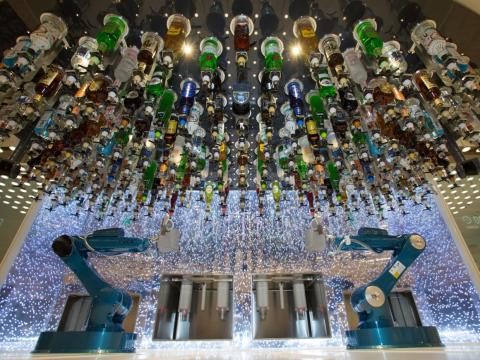 At the Bionic Bar, robot bartenders serve passengers drinks.