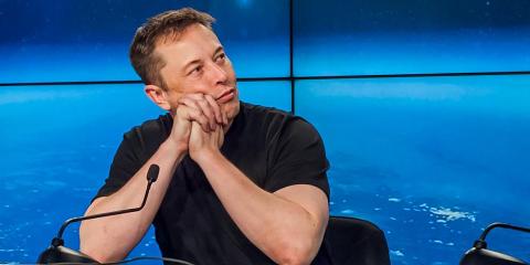 Elon Musk, the founder of SpaceX, watches a replay of the first launch of Falcon Heavy during a press conference on February 6, 2018. Elon Musk, the founder of SpaceX, watches a replay of the first launch of Falcon Heavy during a press conference on February 6, 2018.