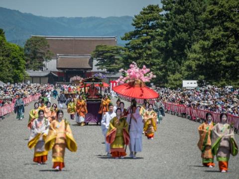 Personas vestidas con trajes del periodo Heian en un desfile en el Palacio Imperial de Kioto por el festival Aoi Matsuri.