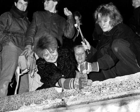 Berliners carried hammers and chisels to begin chipping away at the wall.
