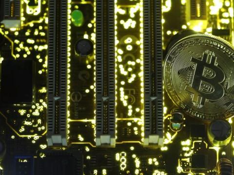 A copy of bitcoin standing on PC motherboard is seen in this illustration picture