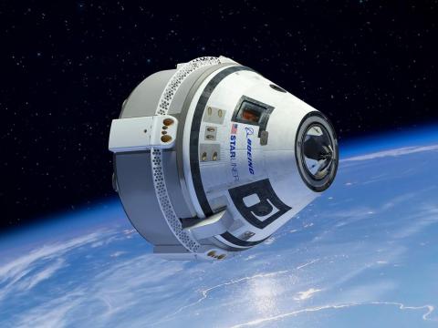 An illustration of Boeing's CST-100 Starliner spaceship flying around Earth.