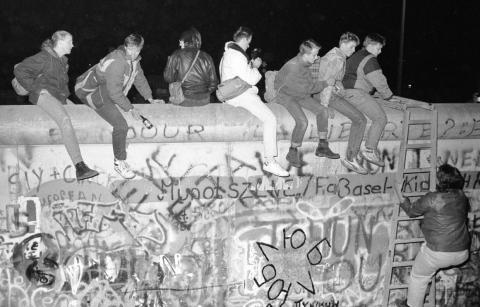 While in the past those trying to cross the border would resort to digging tunnels, leaping out of buildings that lined the border, or attempting to drive through, on November 9 West German citizens climbed freely atop the Berlin
