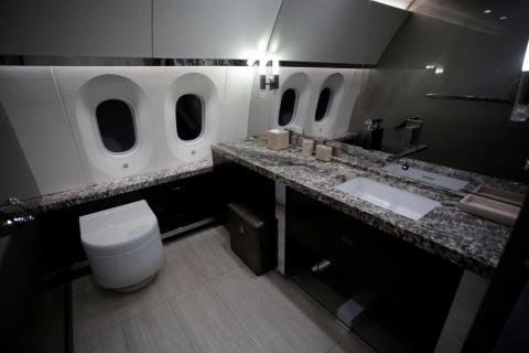 Here is a look at a restroom on the plane complete with stone countertops.