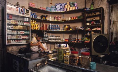 Often, commercial spaces like this grocery store would double as a living room or a space for the children to do homework after the working day was over.