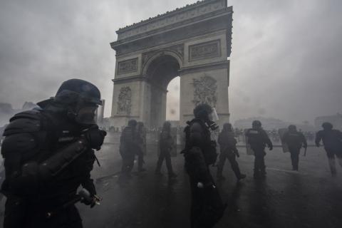 Teargas surrounds riot police