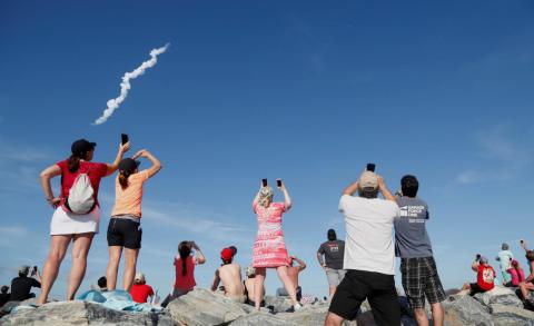Spectators at Cocoa Beach watch SpaceX's first Falcon Heavy rocket launch from the Kennedy Space Center on February 6, 2018. Spectators at Cocoa Beach watch SpaceX's first Falcon Heavy rocket launch from the Kennedy Space Center on February 6, 2018.