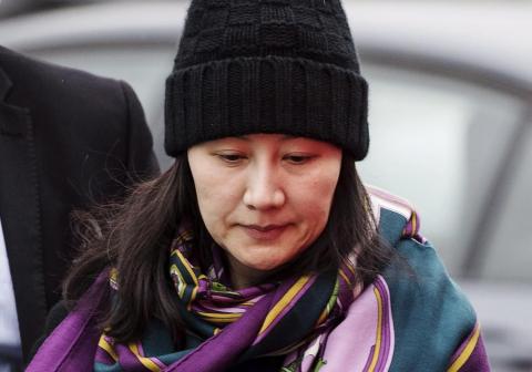 Huawei's chief financial officer, Meng Wanzhou, arriving at a parole office with a security guard in Vancouver, British Columbia.