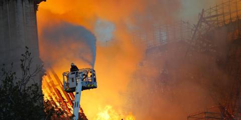 A firefighter at Notre-Dame on Monday night. The fire was fully extinguished on Tuesday morning.