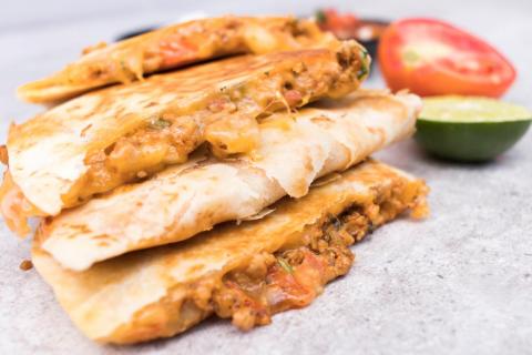 Quesadillas made with canned beans, store-bought tortillas, deli meat, and shredded cheese are considered processed food. Quesadillas made with canned beans, store-bought tortillas, deli meat, and shredded cheese are considered processed food.