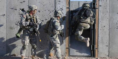 US soldiers conduct breaching operations in a mock-urban environment. US soldiers conduct breaching operations in a mock-urban environment.