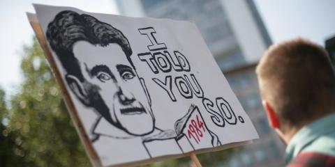 Protesters carrying a placard bearing George Orwell's face show their solidarity with whistle-blower Edward Snowden and demand protection and asylum, on July 27, 2013. Protesters carrying a placard bearing George Orwell's face show their solidarity with whistle-blower Edward Snowden and demand protection and asylum, on July 27, 2013.