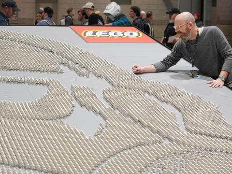 LEGO "Star Wars" design director Jens Kronvold Frederiksen places a final piece on the largest display of LEGO "Star Wars" minifigures at "Star Wars" Celebration in April in Chicago.