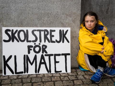 Greta Thunberg sits outside of Riksdagen, the Swedish parliament building, on August 28, 2018 in Stockholm, Sweden.