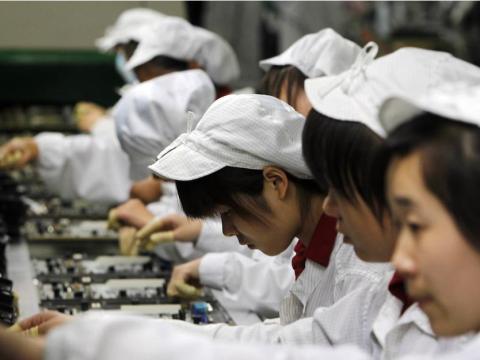 Workers in a Foxconn factory in China. Workers in a Foxconn factory in China.
