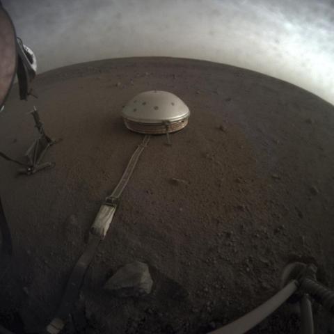 A NASA photo shows the InSight lander's dome-covered seismometer, known as SEIS, on the surface of Mars.