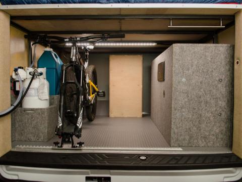 The "garage" has axle mounts to secure the bikes in place. There’s also an on-demand heated shower mounted on the back door.