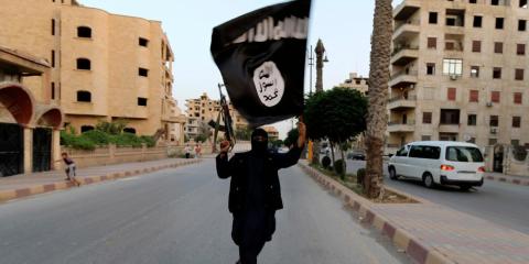 A member loyal to the Islamic State in Iraq and the Levant (ISIL) waves an ISIL flag in Raqqa June 29, 2014. A member loyal to the Islamic State in Iraq and the Levant (ISIL) waves an ISIL flag in Raqqa June 29, 2014.