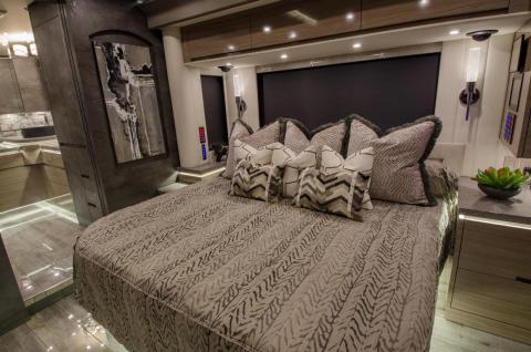 The bedroom has a "junior-king-size bed" with nightstands by its sides.