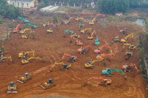 Excavators at the construction site of a new hospital being built to treat patients from a deadly virus outbreak in Wuhan.