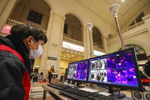 A worker monitors display screens for infrared thermometers as part of traveler screenings at Hankou Railway Station in Wuhan, China, January 21, 2020.