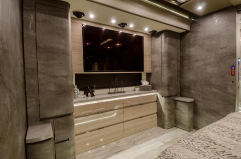 There are multiple televisions throughout the unit, including a 49-inch TV in the overhead, a 28-inch one at the dinette, and a 55-inch one in the bedroom.