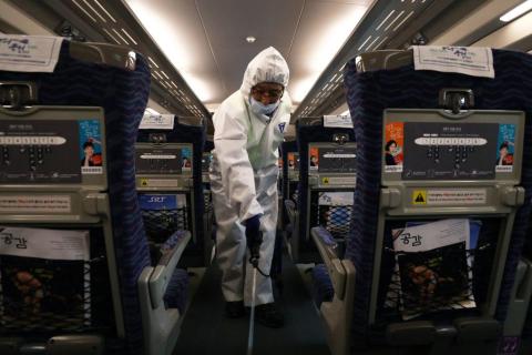 A disinfection worker wearing protective gears spray anti-septic solution in an train amid rising public concerns over the spread of China's Wuhan Coronavirus at SRT train station on January 24, 2020 in Seoul, South Korea.