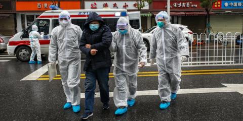 Medics help a patient walk into a hospital in Wuhan, China, on January 26, 2020. Medics help a patient walk into a hospital in Wuhan, China, on January 26, 2020.