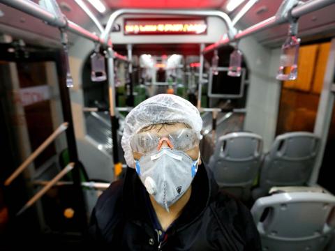 A Tehran municipality worker cleans a bus to avoid the spread of the COVID-19 virus on February 26, 2020. A Tehran municipality worker cleans a bus to avoid the spread of the COVID-19 virus on February 26, 2020.