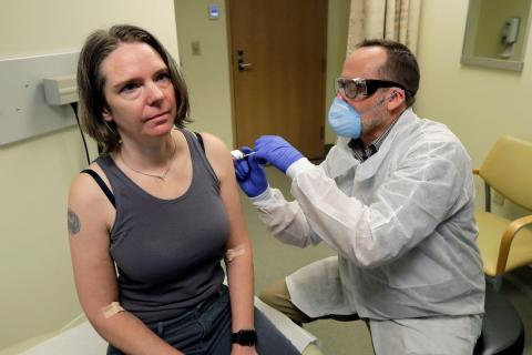 A pharmacist gives Jennifer Haller the first shot in the first-stage safety study clinical trial of a vaccine for COVID-19.