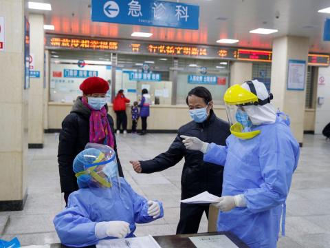 Nurses in protective gear talk to people in the reception area of the First People's Hospital in Yueyang, Hunan Province, China, January 28, 2020. Nurses in protective gear talk to people in the reception area of the First People's Hospital in Yueyang, Hunan Province, China, January 28, 2020.