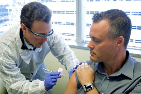 Neal Browning gets a shot of the vaccine.