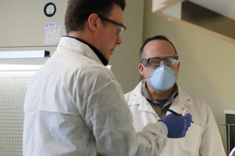 Pharmacists talk after prepping to administer the vaccine trial.