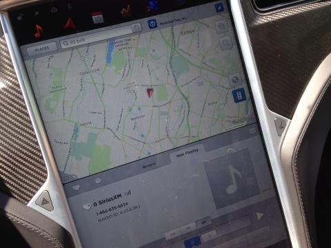 The Model S is equipped with a large, 17-inch portrait central touchscreen that controls climate and infotainment, as well as many vehicle settings. The screen is angled slightly toward the driver.