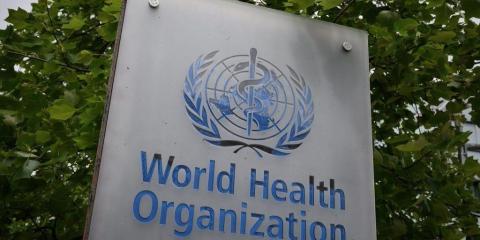 This picture taken on May 12, 2020, shows a sign of the World Health Organization (WHO) in Geneva next to their headquarters, amid the COVID-19 outbreak, caused by the novel coronavirus.