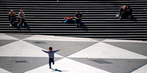 A boy runs across a square in Stockholm, Sweden on May 8, 2020. A boy runs across a square in Stockholm, Sweden on May 8, 2020.