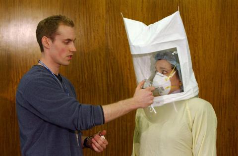 Staff at Royal Columbian Hospital demonstrate safety measures to protect against SARS on April 22, 2003 in New Westminster, British Columbia, Canada.
Don MacKinnon/Getty Images
