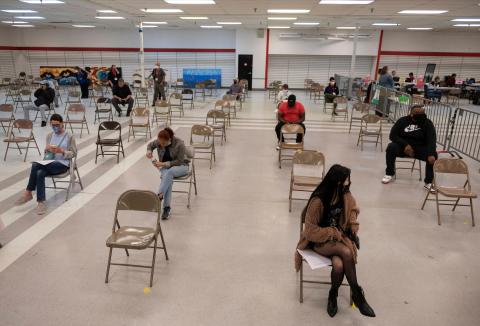 People wait in an observation area after getting COVID-19 vaccines at an old TJ Maxx store in Lynchburg, Virginia on March 13, 2021.