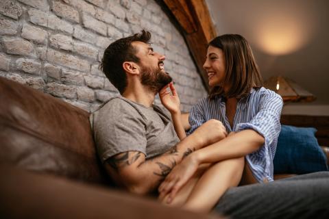 Young couple laughing at home