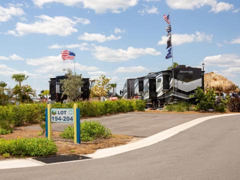 Two RVs with flags parked at Camp Margaritaville.