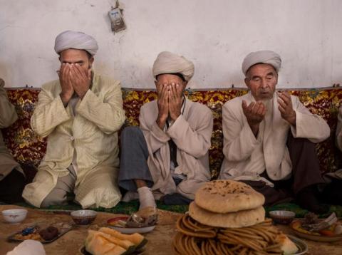 Uighur men pray before a meal during the Corban Festival, also known as Eid al-Adha, in Turpan, Xinjiang, in September 2016. Uighur men pray before a meal during the Corban Festival, also known as Eid al-Adha, in Turpan, Xinjiang, in September 2016.