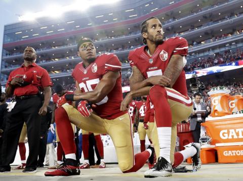Colin Kaepernick, right, began kneeling during the national anthem before NFL games as a protest against police brutality and racial injustice. Colin Kaepernick, right, began kneeling during the national anthem before NFL games as a protest against police brutality and racial injustice.