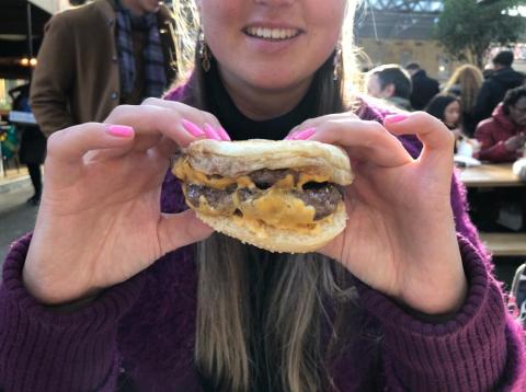 Writer Rachel Hosie flipping her burger upside down. Writer Rachel Hosie flipping her burger upside down.