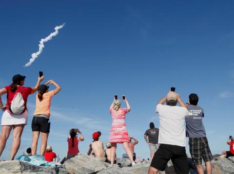 Spectators at Cocoa Beach watch SpaceX's first Falcon Heavy rocket launch from the Kennedy Space Center on February 6, 2018. Spectators at Cocoa Beach watch SpaceX's first Falcon Heavy rocket launch from the Kennedy Space Center on February 6, 2018.