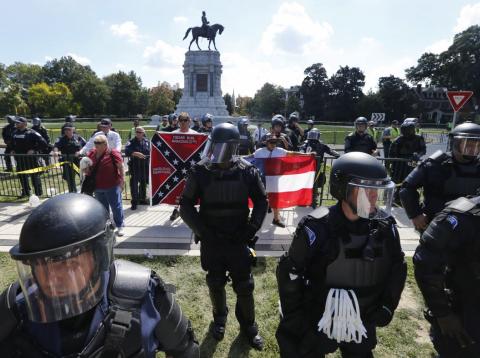 State Police keep a handful of Confederate protesters separated from counter demonstrators in front of the statue of Confederate General Robert E. Lee on Monument Avenue in Richmond, Virginia, Saturday, Sept. 16, 2017. State Police keep a handful of Confederate protesters separated from counter demonstrators in front of the statue of Confederate General Robert E. Lee on Monument Avenue in Richmond, Virginia, Saturday, Sept. 16, 2017.