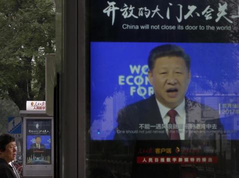 A man walks by electronic display panels advertising a video footage of Chinese President Xi Jinping speaking at the World Economy Forum on a street in Beijing, Monday, June 25, 2018. A man walks by electronic display panels advertising a video footage of Chinese President Xi Jinping speaking at the World Economy Forum on a street in Beijing, Monday, June 25, 2018.