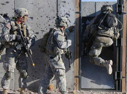 US soldiers conduct breaching operations in a mock-urban environment. US soldiers conduct breaching operations in a mock-urban environment.