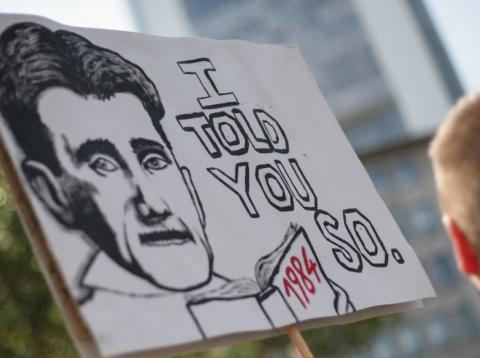 Protesters carrying a placard bearing George Orwell's face show their solidarity with whistle-blower Edward Snowden and demand protection and asylum, on July 27, 2013. Protesters carrying a placard bearing George Orwell's face show their solidarity with whistle-blower Edward Snowden and demand protection and asylum, on July 27, 2013.